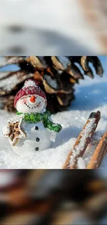 Snowman in snow with pine cone and cinnamon sticks mobile wallpaper.