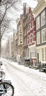 Snow-covered Amsterdam street with bicycles and historic buildings.