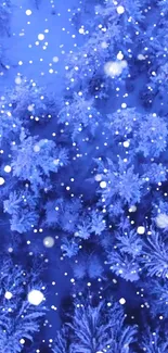 Snowy blue forest with falling snowflakes wallpaper.