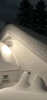 Snow-covered cabin at night with glowing light.