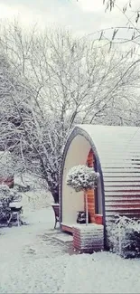 Snowy cabin surrounded by trees in a winter scene.