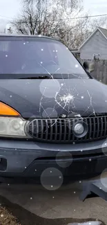 Parked car with snowflakes falling on a suburban street in winter.