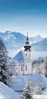 Serene snowy chapel with mountains in winter.