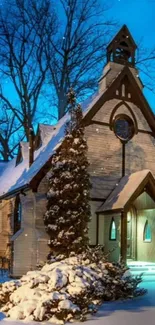 Snow-covered church at dusk with blue sky and twinkling lights.