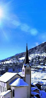 Stunning snowy church with bright blue sky and sunlit mountain village backdrop.