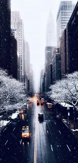 Snow-covered city street with yellow taxis and skyscrapers.