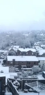 Snow-covered cityscape with misty winter sky.