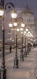 Snowy bridge with glowing street lamps and cathedral in the background.