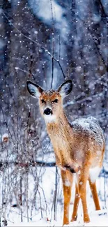 A deer stands in a snowy forest with falling snow, creating a tranquil winter scene.