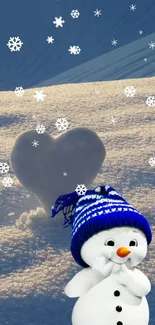 Cute snowman with blue hat and heart-shaped snow in winter landscape.