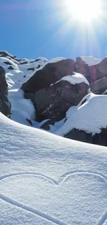 Heart-shaped snow art on a sunlit mountain slope.