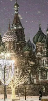 Snow-covered Kremlin in Moscow at night with lights and festive snow.