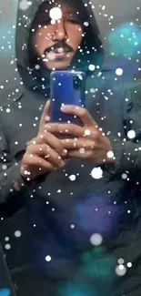 Hooded man in mirror with snow effect on phone wallpaper.