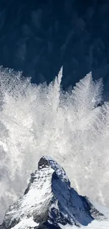 Snowy mountain with ice crystals against a blue sky.