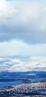 Serene snowy mountain landscape under a vast blue sky.