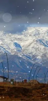 Snowy mountains under a cloudy sky, perfect for a serene mobile wallpaper.