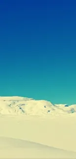 Snowy mountain landscape under a clear sky.