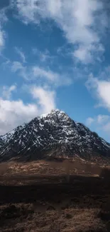 Snowy mountain with blue sky and clouds, perfect for a calming phone wallpaper.