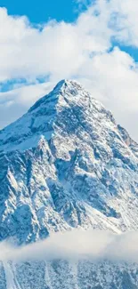 Majestic snow-covered mountain against a blue sky wallpaper.