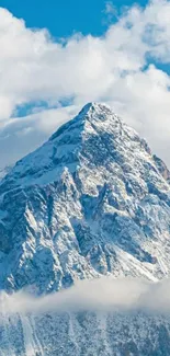 Snowy mountain peak with blue sky and clouds.