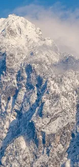 Snow-covered mountain peak under a clear blue sky, exuding winter serenity.