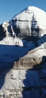 Majestic snowy mountain peak under a blue sky.