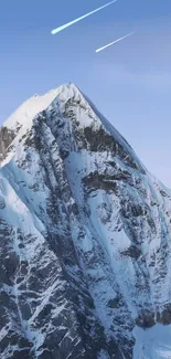 Snowy mountain peak against a clear blue sky with meteor trails.