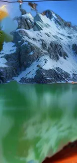 Snowy mountain reflected on a serene lake under a clear blue sky.