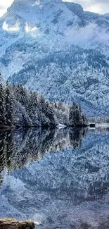 Snowy mountain landscape with lake reflection.