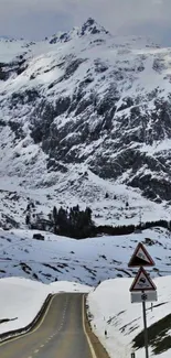 Snowy mountain road with scenic views.