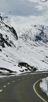 Scenic snowy mountain road mobile wallpaper.