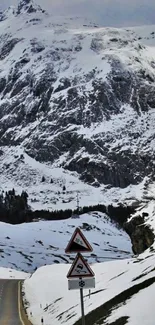 Beautiful snowy mountain road wallpaper with scenic views.