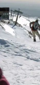 Snowy mountain slope with a skier descending.