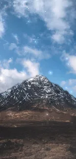 Snow-capped mountain peaks under a bright blue sky with scattered clouds.