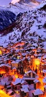 Snow-covered village in evening glow with mountain backdrop.