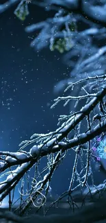 Snowy branches in moonlit night scene wallpaper.