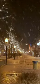 Snow-covered city street illuminated by glowing streetlights at night.