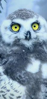 Snowy owl with vivid yellow eyes in a serene forest setting.