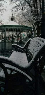 Snow-covered park bench in tranquil winter setting.