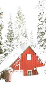 Red cabin surrounded by snowy forest landscape.