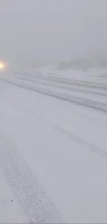 Snowy road in winter with misty atmosphere.