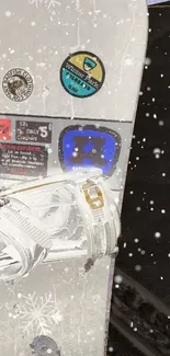 Close-up of a snowboard with snowy details and winter stickers.