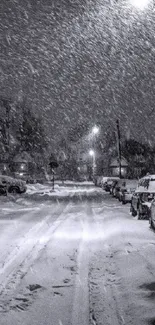 Snowy street scene at night with cars and streetlights.