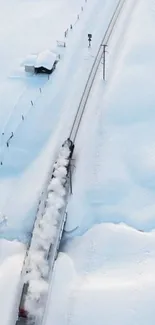 Aerial view of a train traveling through a snowy landscape.