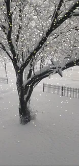 Snow-covered tree with sparkling lights in a winter landscape.