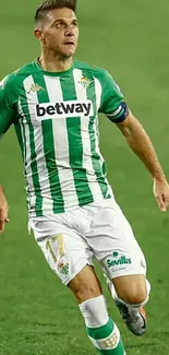 Soccer player from Real Betis in mid-action on the field.