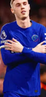 Soccer player celebrating in a blue jersey.