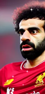 Soccer player in red jersey, focused and determined.