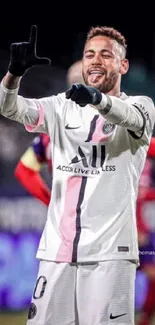 Soccer player in white jersey celebrating.