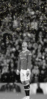 Soccer player in black and white with gold sparkles background.